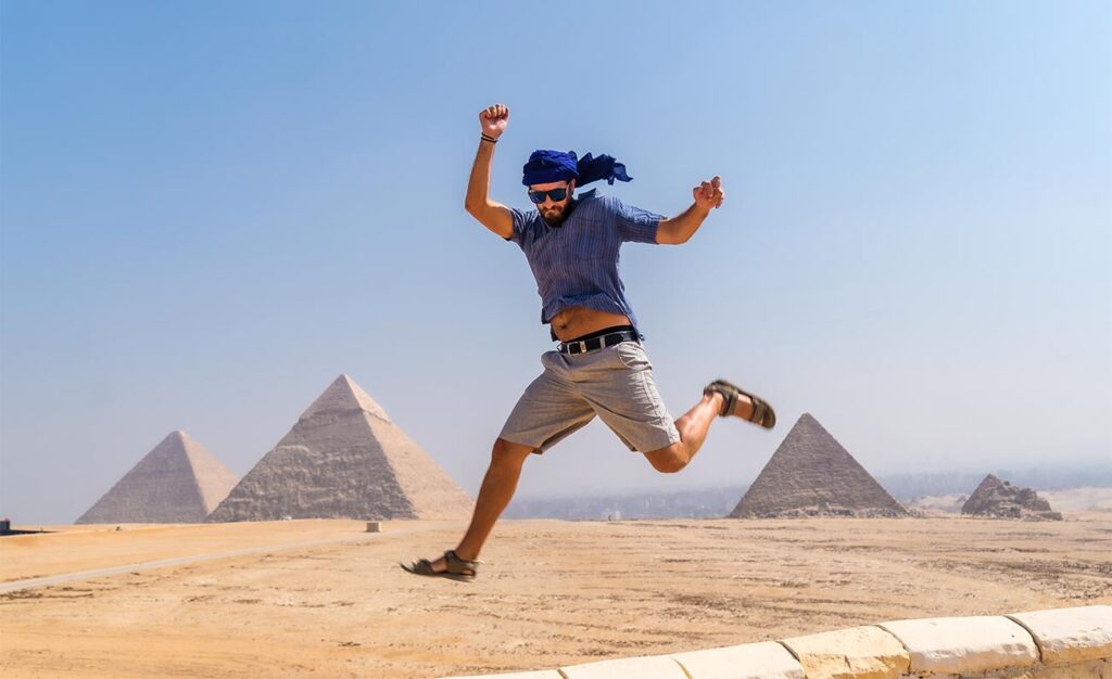a-young-tourist-jumping-for-joy-in-a-blue-turban-a-2022-03-09-22-06-57-utc