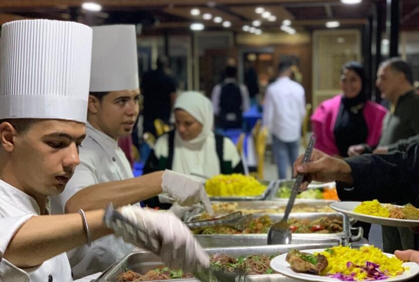 Chef serving guests at the open buffet on a Cairo Nile dinner cruise