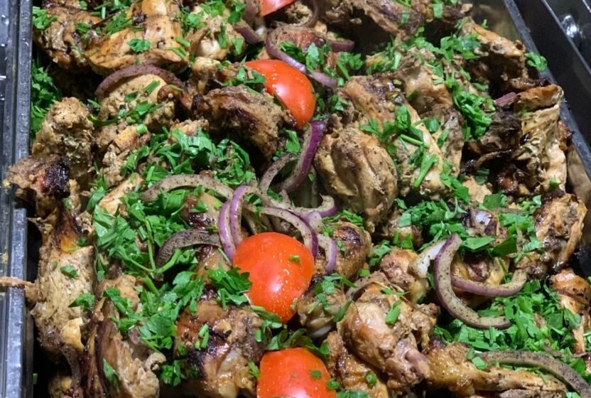 Egyptian grilled dish with fresh herbs at the Nile cruise buffet