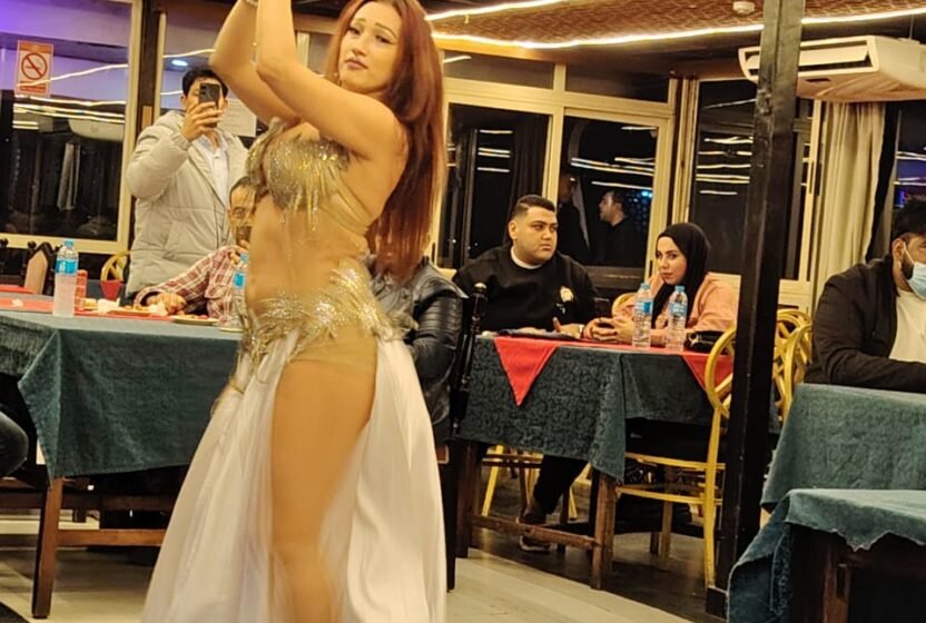 Belly dancer performing among the tables on a Cairo dinner cruise