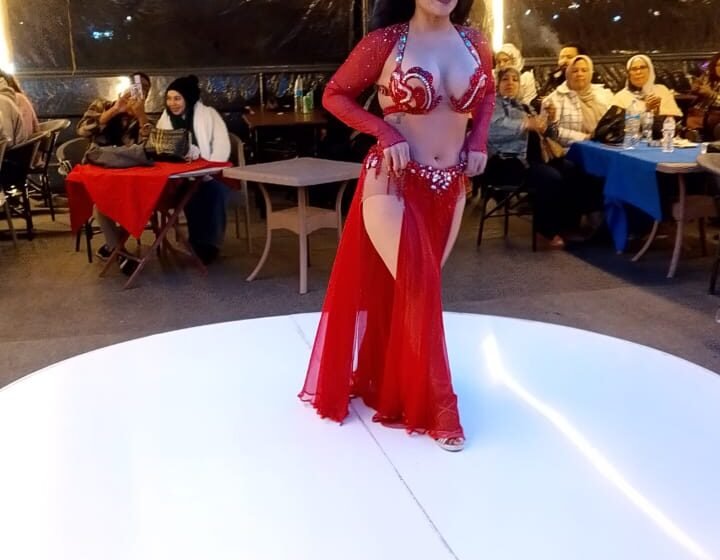 Tanoura dancer in red performing on the Nile dinner cruise