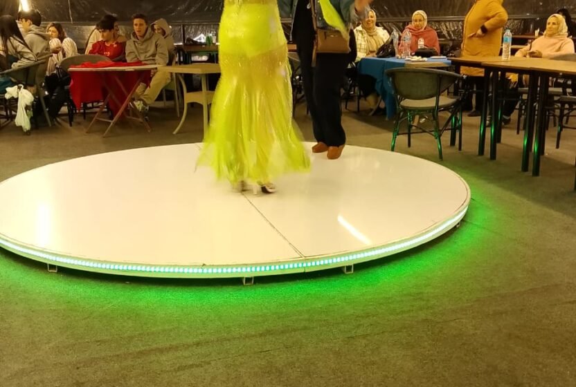 Belly dancer on the lit stage of a Cairo Nile dinner cruise