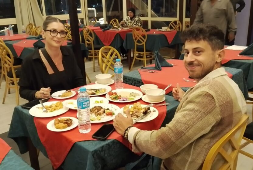 Guests enjoying dinner at their table on a Cairo Nile cruise